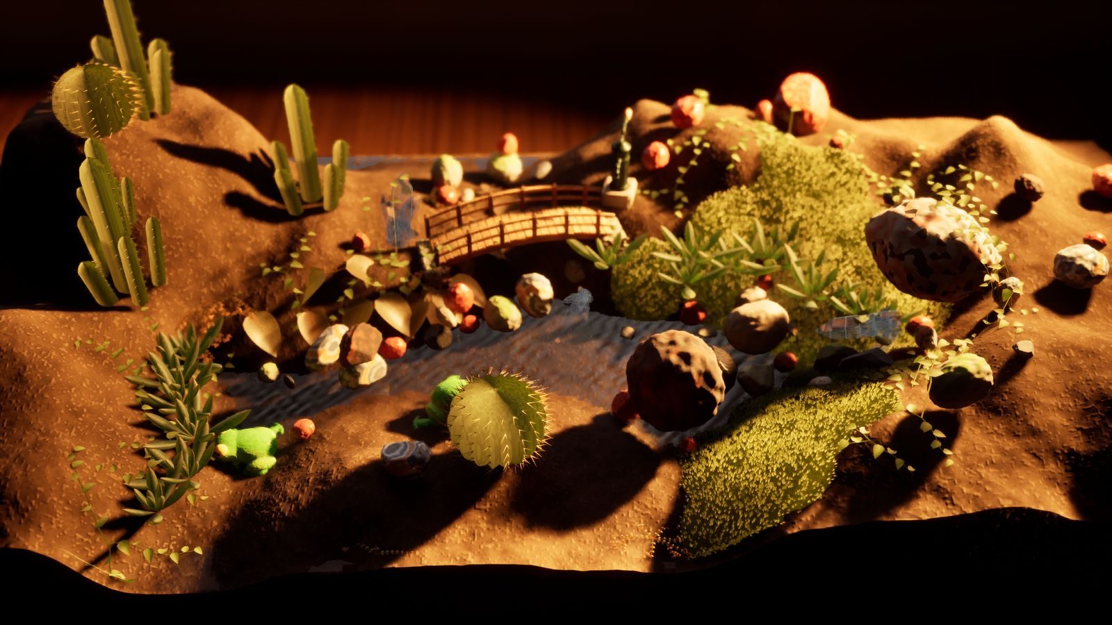 A desert terrarium with cacti, a footbridge and a frog in low sun